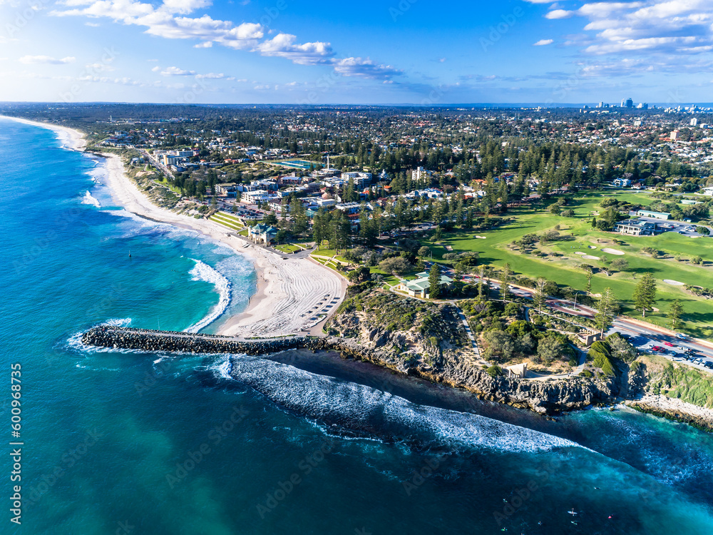 Aerial top down view of beach and clear blue water. Ocean waves on the beach as a background. Beautiful natural summer vacation holidays background. Cottesloe, Western Australia. Coastal seascapes