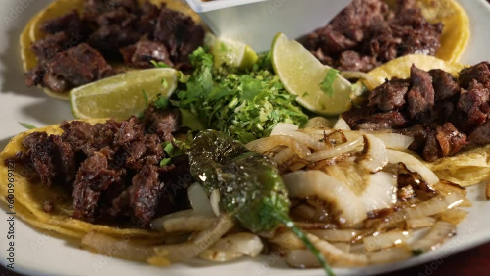 Traditional carne asada steak street tacos on corn tortillas with grilled onions cilantro and borracho beans, close up slider 4K Traditional carne asada steak street tacos on corn tortillas with grilled onions cilantro and borracho beans, close up slider 4K