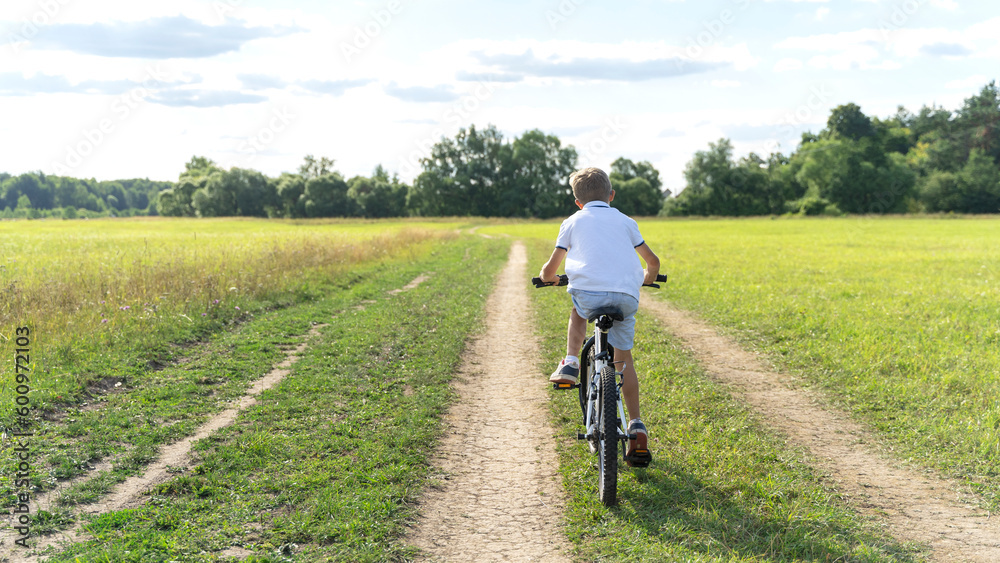 a boy learns to ride a bike in the park a boy learns to ride a bike in the park