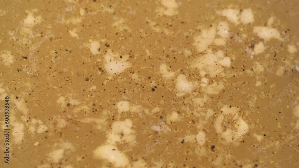 stir of saturated broth for making aspic closeup. beef and pork bone broth, side view. delicious healthy food with collagen content. selective focus. stir of saturated broth for making aspic closeup. beef and pork bone broth, side view. delicious healthy food with collagen content. selective focus.