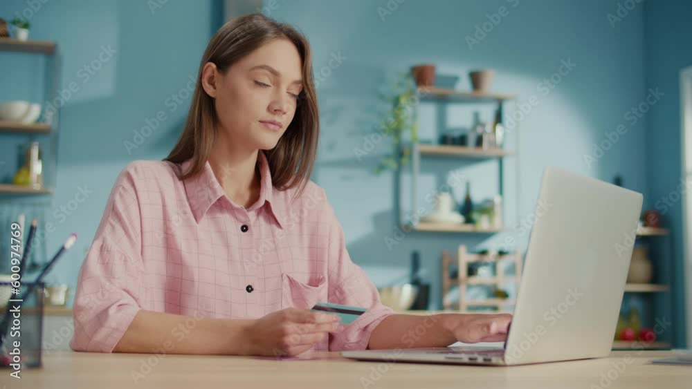 Happy Young Woman Makes a Purchase in the Online Store With a Credit Card. Woman Consumer Paying for Purchase in Web Store Using Laptop Technology. Ecommerce Website Payments Concept. Happy Young Woman Makes a Purchase in the Online Store With a Credit Card. Woman Consumer Paying for Purchase in Web Store Using Laptop Technology. Ecommerce Website Payments Concept.
