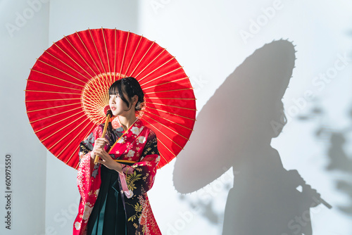 Portrait of Asian girl wearing kimono. Japanese traditional dress. Memorial ceremony. Photo studio.