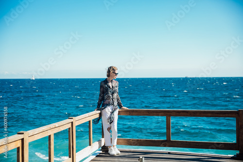 a woman stands at the railing on the sea voyage boat trip