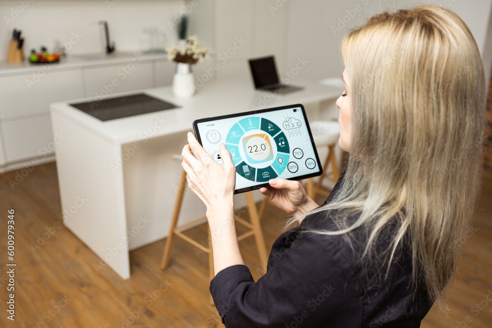 Woman at home using smart screen, automation domestic system Woman at home using smart screen, automation domestic system