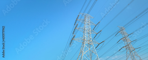 Obraz na płótnie Looking up steel power pylon construction with high voltage cables against blue sky. Wide banner for electric energy industry with space for text on left side w salonie