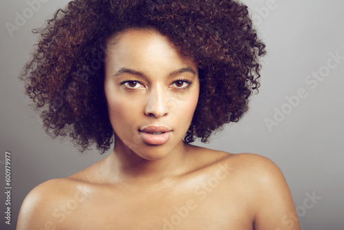 Serious, portrait and a black woman for skincare and beauty isolated on studio background. Wellness, dermatology and face of an African girl with a glow from care for skin and cosmetic salon results