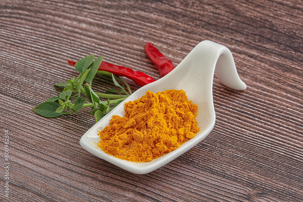 Yellow vibrant curcuma powder in the bowl Yellow vibrant curcuma powder in the bowl