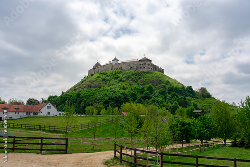 Sumeg castle on the hill in Hungary springtimewith green trees photo