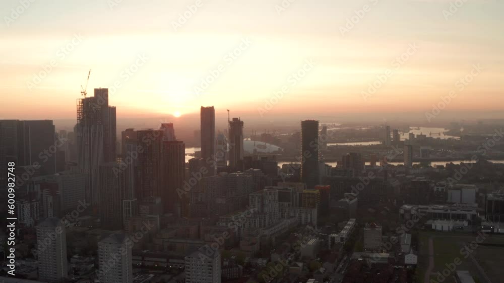 Aerial slider shot from large skyscrapers to small residential buildings Canary Wharf sunrise Aerial slider shot from large skyscrapers to small residential buildings Canary Wharf sunrise