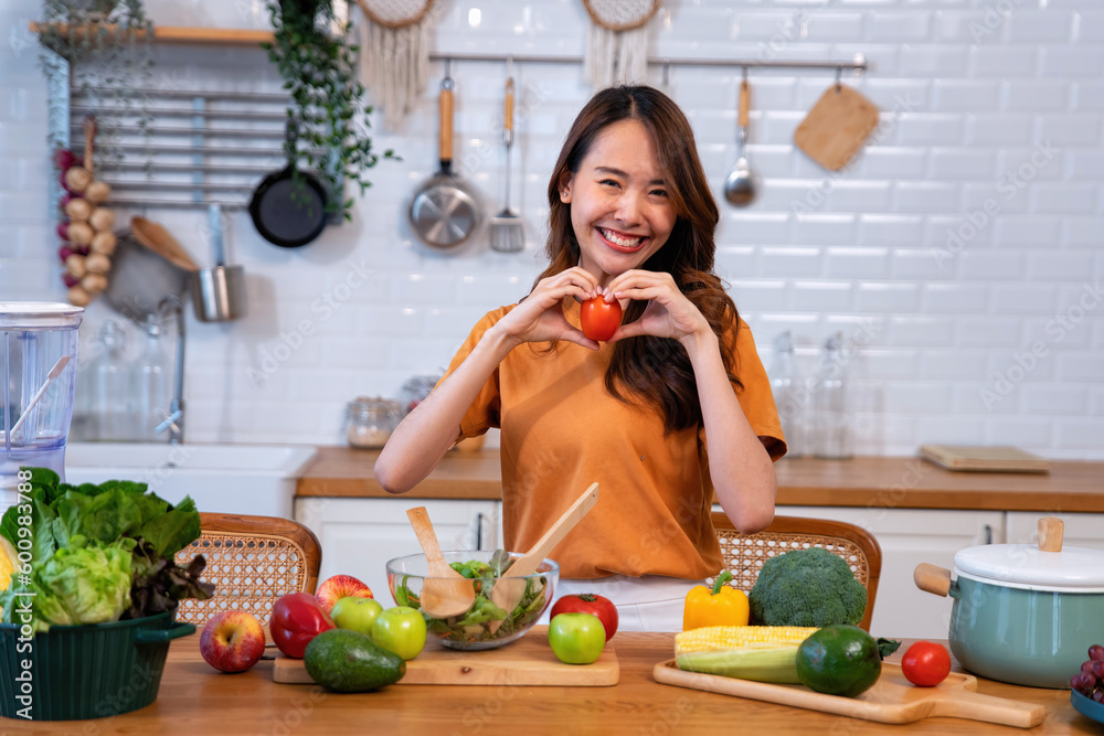 Beautiful young woman happy portrait cooking fresh organic clean food fruit at home modern kitchen Beautiful young woman happy portrait cooking fresh organic clean food fruit at home modern kitchen