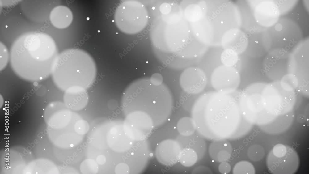 Glittering white bokeh on a black background. a drop of shiny particles. Decorative Luxury element. Glittering white bokeh on a black background. a drop of shiny particles. Decorative Luxury element.