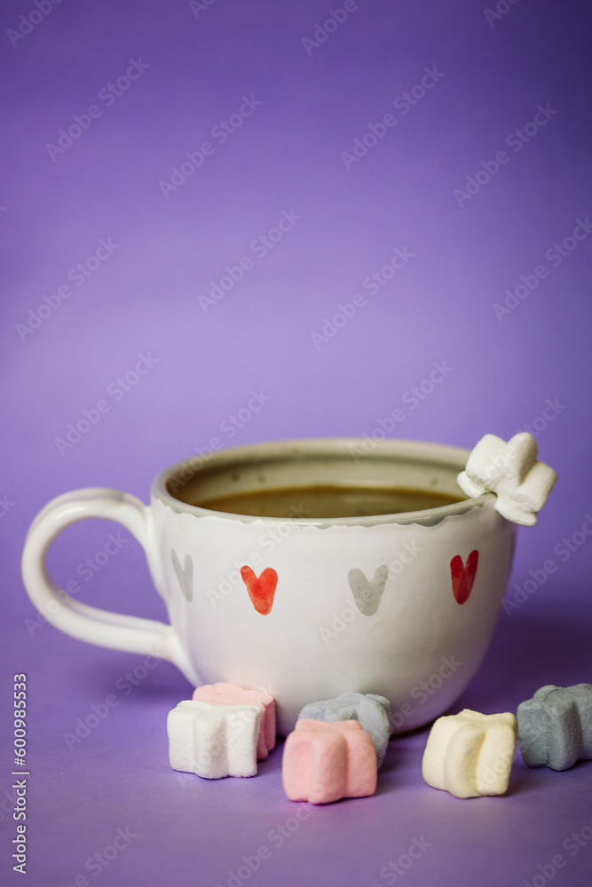 A cup of coffee, cocoa, chocolate with hearts on a lilac violet background. Marshmallows on a table. Cozy still life with hot drink made with love, sweets. February 14, Happy Valentines Day concept. A cup of coffee, cocoa, chocolate with hearts on a lilac violet background. Marshmallows on a table. Cozy still life with hot drink made with love, sweets. February 14, Happy Valentines Day concept.