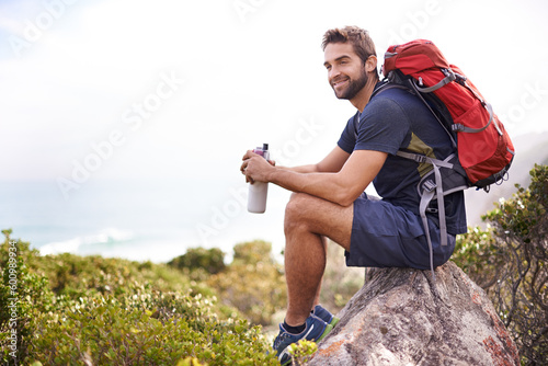Foto Hiking, mountain and man rest on a rock thinking after exercise, workout and fitness in nature for wellness