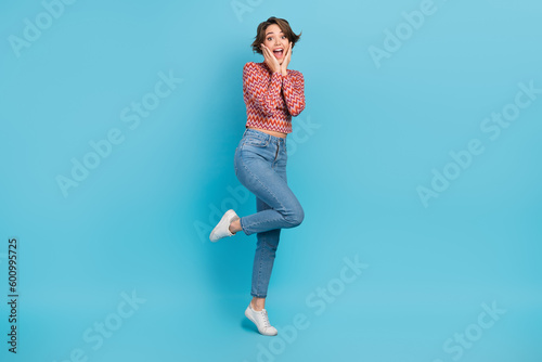 Full length photo of sweet impressed lady wear pink shirt smiling open mouth arms cheeks isolated blue color background