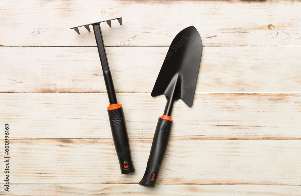 Gardening tools on wooden background, top view