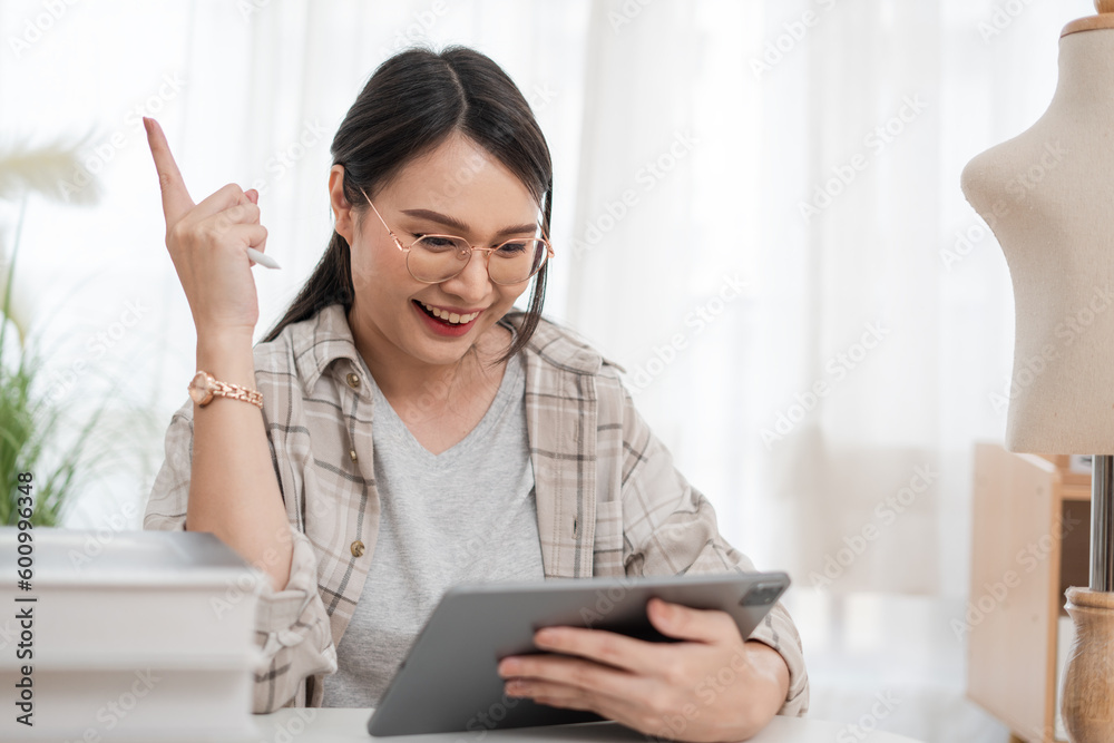 Asian women, tailor the small business concept using tablet digital video call Asian women, tailor the small business concept using tablet digital video call