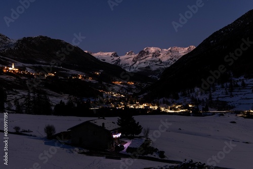 Champoluc and Antagnod viewed in the night with lights and mountains in the background, Aosta Valley, Italy photo
