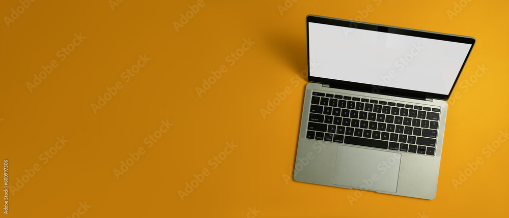 Laptop computer with white empty screen on yellow background with copy space for your advertise text Laptop computer with white empty screen on yellow background with copy space for your advertise text