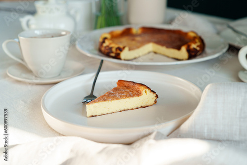 Beautiful served slice of fresh baked basque cheesecake on a table, healthy baked food