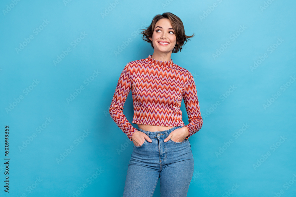 Photo of cute sweet lady wear pink shirt arms hands pockets looking empty space isolated blue color background - obrazy, fototapety, plakaty 
