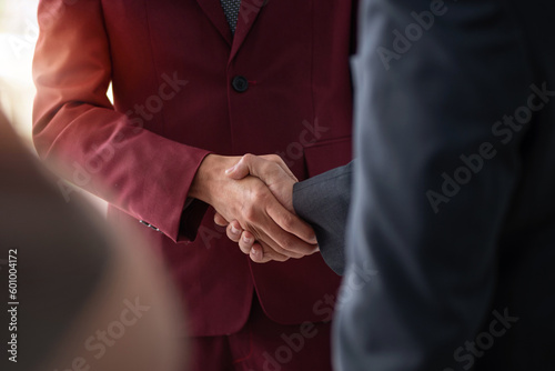 Young Indian businessman shaking hands with customer after reaching business deal