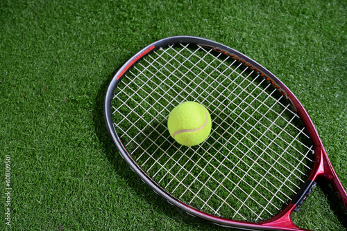 tennis ball with racket on glass court SC © taveesaksri