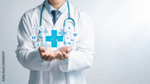 Fototapeta Naklejka Na Ścianę i Meble -  Male medicine doctor hold healthcare medical icons for the Health insurance concept in hospital background