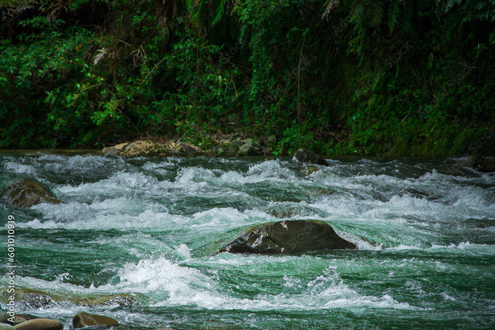Clear water turning over rocks in a rapid river. Close up Clear water turning over rocks in a rapid river. Close up