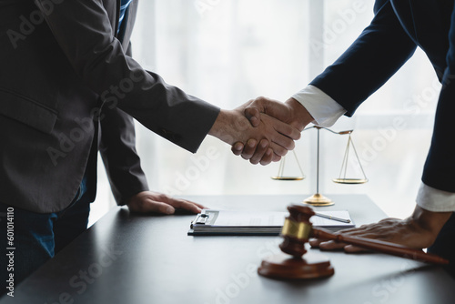 Businessmen, investors shake hands with lawyers to sign partnership agreements involved in financing the business together.