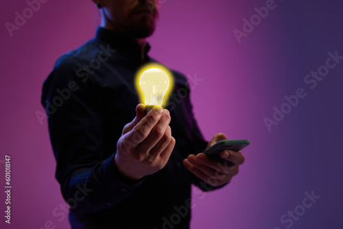 Working on profits and company success. Businessman holding light bulb symbolize innovation, modern professional approach. Concept of business, modern technologies, network, digitalization
