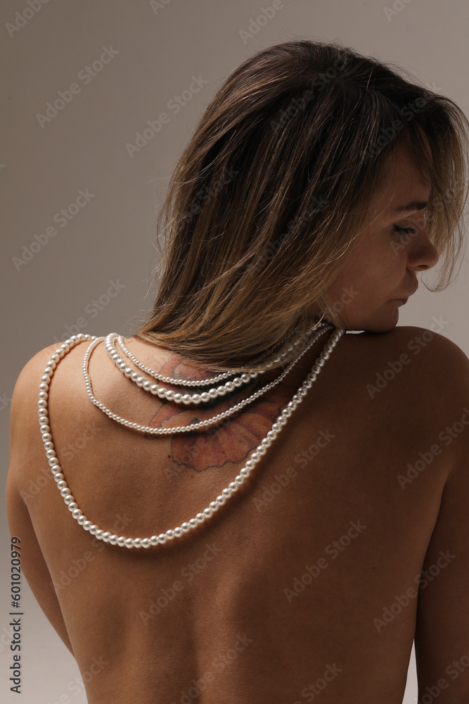 Vertical portrait of young stylish woman wearing pearl necklace. Mock-up.