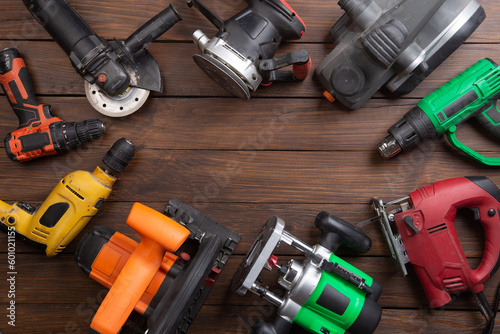 Set of electric tools on the wooden table. Various power tools for renovation and construction