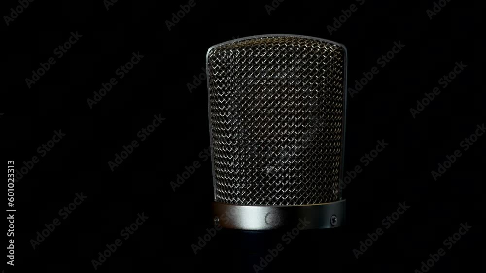 Large studio condenser microphone on a dark background Large studio condenser microphone on a dark background