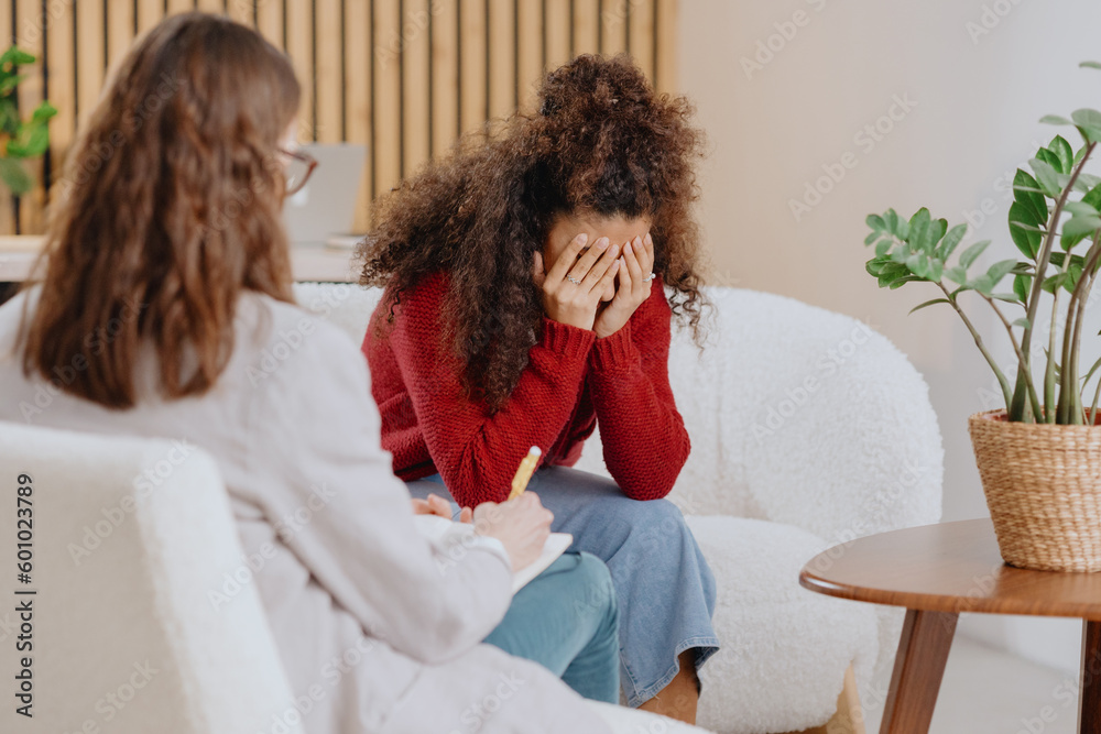 African American woman at psychotherapist's appointment, moral support, solving problems in relationship, tells psychologist about feelings and experiences. mental health and intelligence. depression African American woman at psychotherapist's appointment, moral support, solving problems in relationship, tells psychologist about feelings and experiences. mental health and intelligence. depression