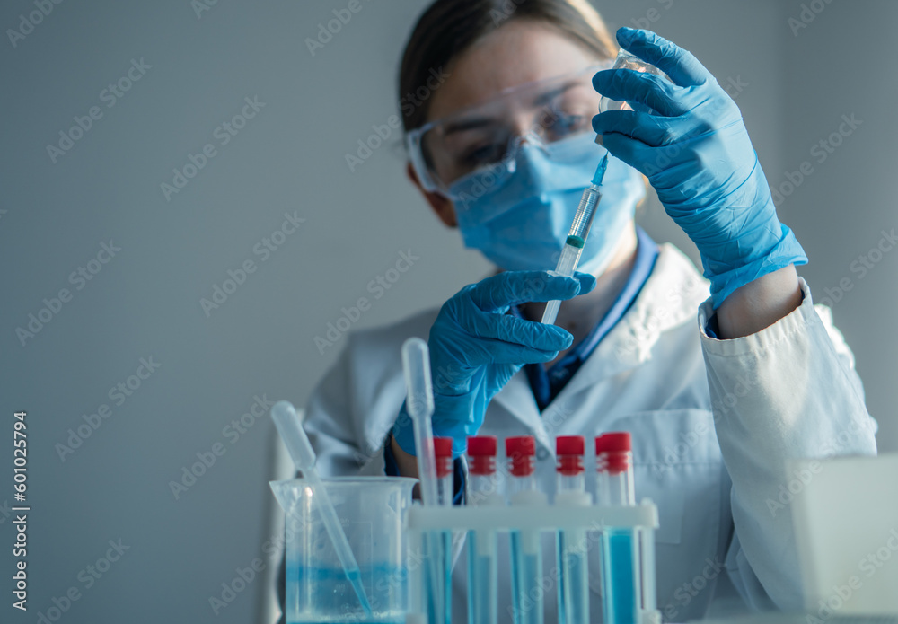 Scientist analyzes new drug in chemical laboratory, finding out whether it can be effective for treating certain diseases. Medical worker prepares syringe injection with medicine in medical laboratory Scientist analyzes new drug in chemical laboratory, finding out whether it can be effective for treating certain diseases. Medical worker prepares syringe injection with medicine in medical laboratory