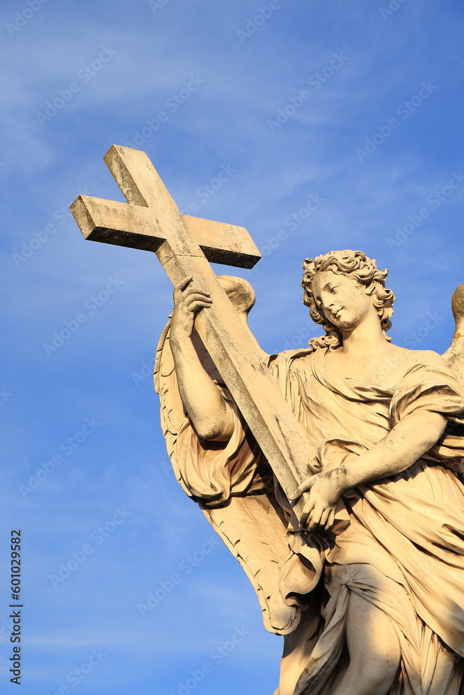 Naklejka premium Ponte Sant'Angelo Bridge Statue of an Angel Holding the Cross Detail in Rome, Italy