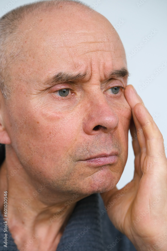 close-up of charismatic mature man, senior 60 years old looks carefully examines wrinkles on face, skin folds, age-related skin changes, aesthetic injection cosmetology, care anti-aging procedures close-up of charismatic mature man, senior 60 years old looks carefully examines wrinkles on face, skin folds, age-related skin changes, aesthetic injection cosmetology, care anti-aging procedures