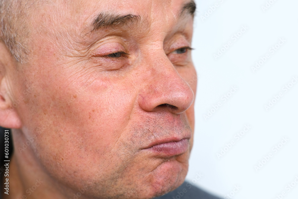 close-up male face makes negative grimaces aggression, mature man, senior 60 years old with foolish threatening facial expression, concept mental human health, optimism in adulthood, midlife crisis close-up male face makes negative grimaces aggression, mature man, senior 60 years old with foolish threatening facial expression, concept mental human health, optimism in adulthood, midlife crisis