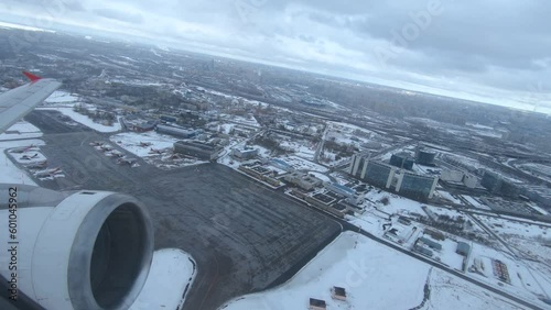 a take off of an airplane at the airport the engine is visible from the window of the airplane