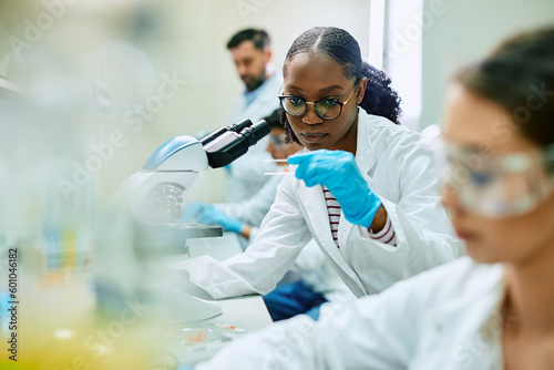 Black female pharmaceutical student during research in laboratory.