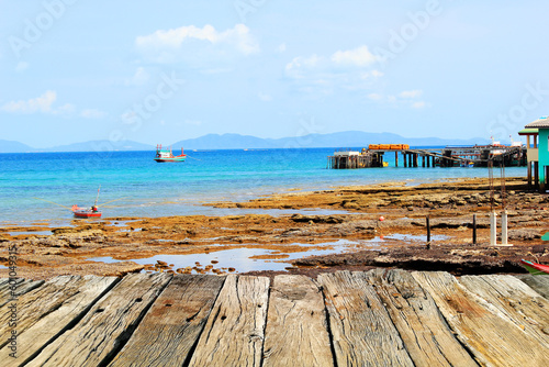Wooden pier on the beach in Thailand. © Natthawut