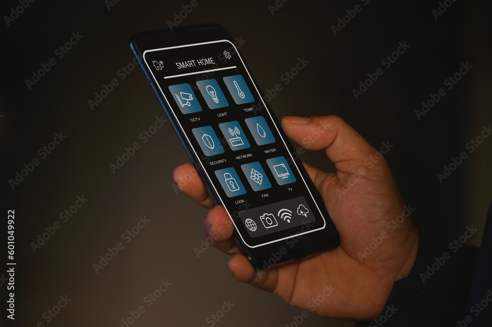 Smart home automation. hands holding smartphone to control the Electrical Smart home automation. hands holding smartphone to control the Electrical