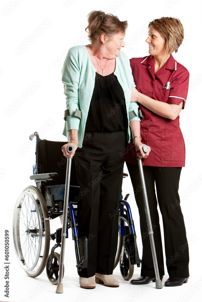 Health Professionals: Rehabilitation. A senior patient being helped back onto her feet by an encouraging nurse. From a series of related images. Health Professionals: Rehabilitation. A senior patient being helped back onto her feet by an encouraging nurse. From a series of related images.