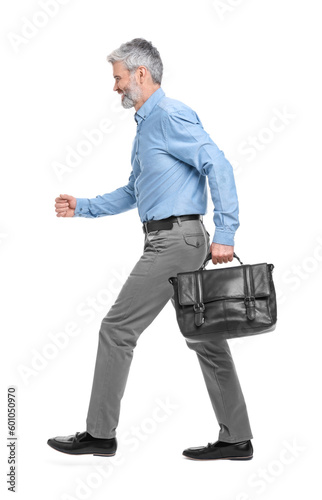 Mature businessman in stylish clothes with briefcase walking on white background