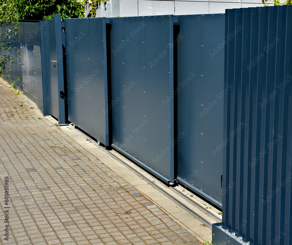 metal fillings of the fence with an underlay of concrete blocks. A