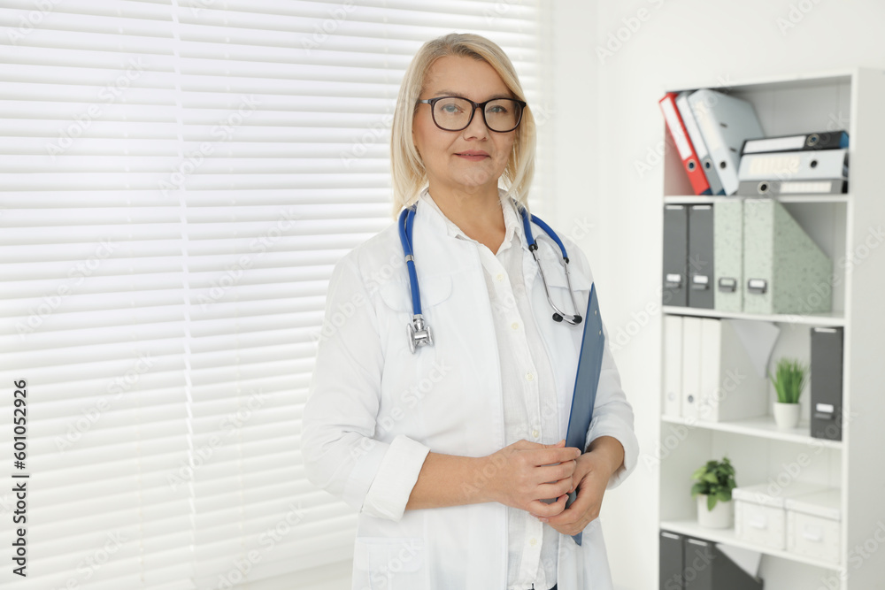Doctor with stethoscope in clinic, space for text Doctor with stethoscope in clinic, space for text