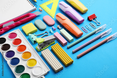 Different school stationery on light blue background. Back to school