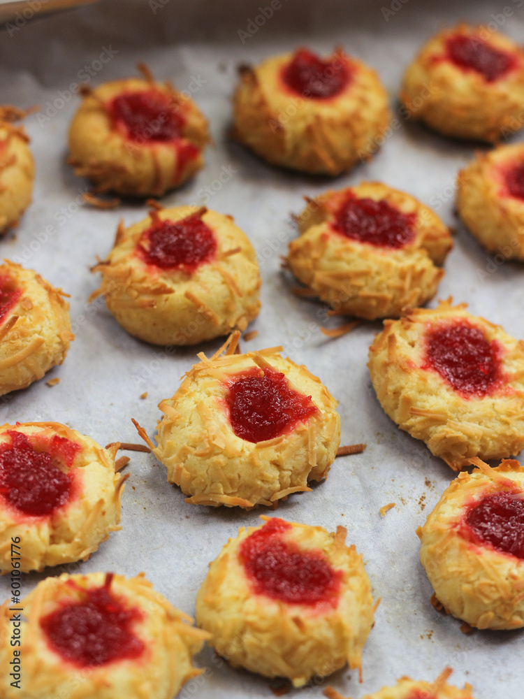Homemade thumb print cookies filled with strawberry jam and grated cheese