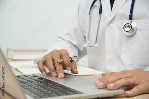Medicine doctor in medical uniform working with computer notebook at desk in the hospital