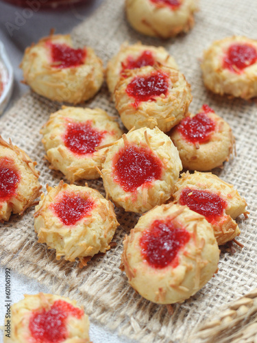 Homemade thumb print cookies filled with strawberry jam and grated cheese